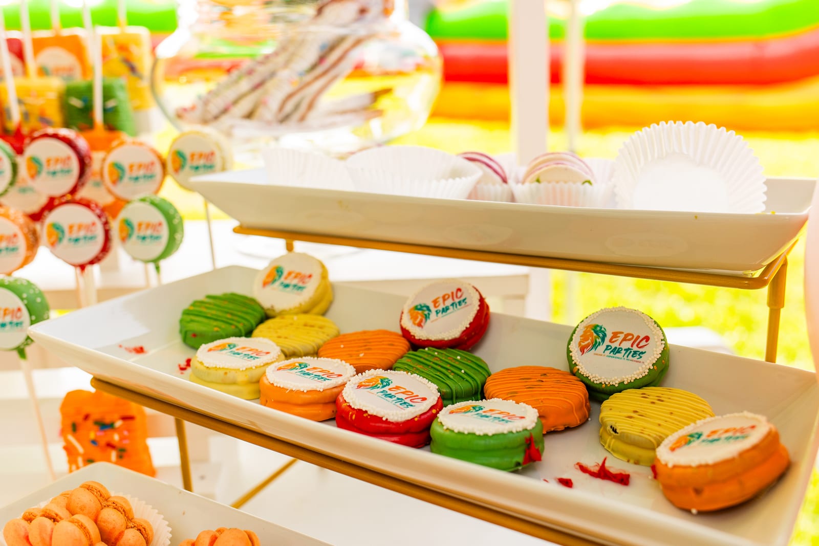 Tiered dessert stand of iced cookies printed with the EPIC Parties logo
