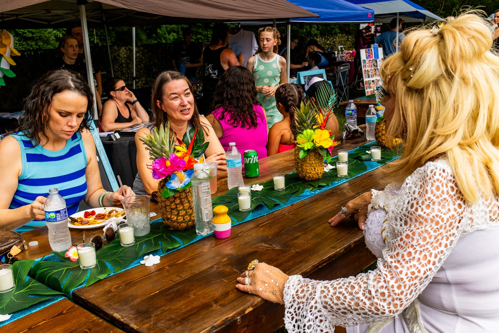 Guests seated along a long tropical banquet table with pineapple centrepieces