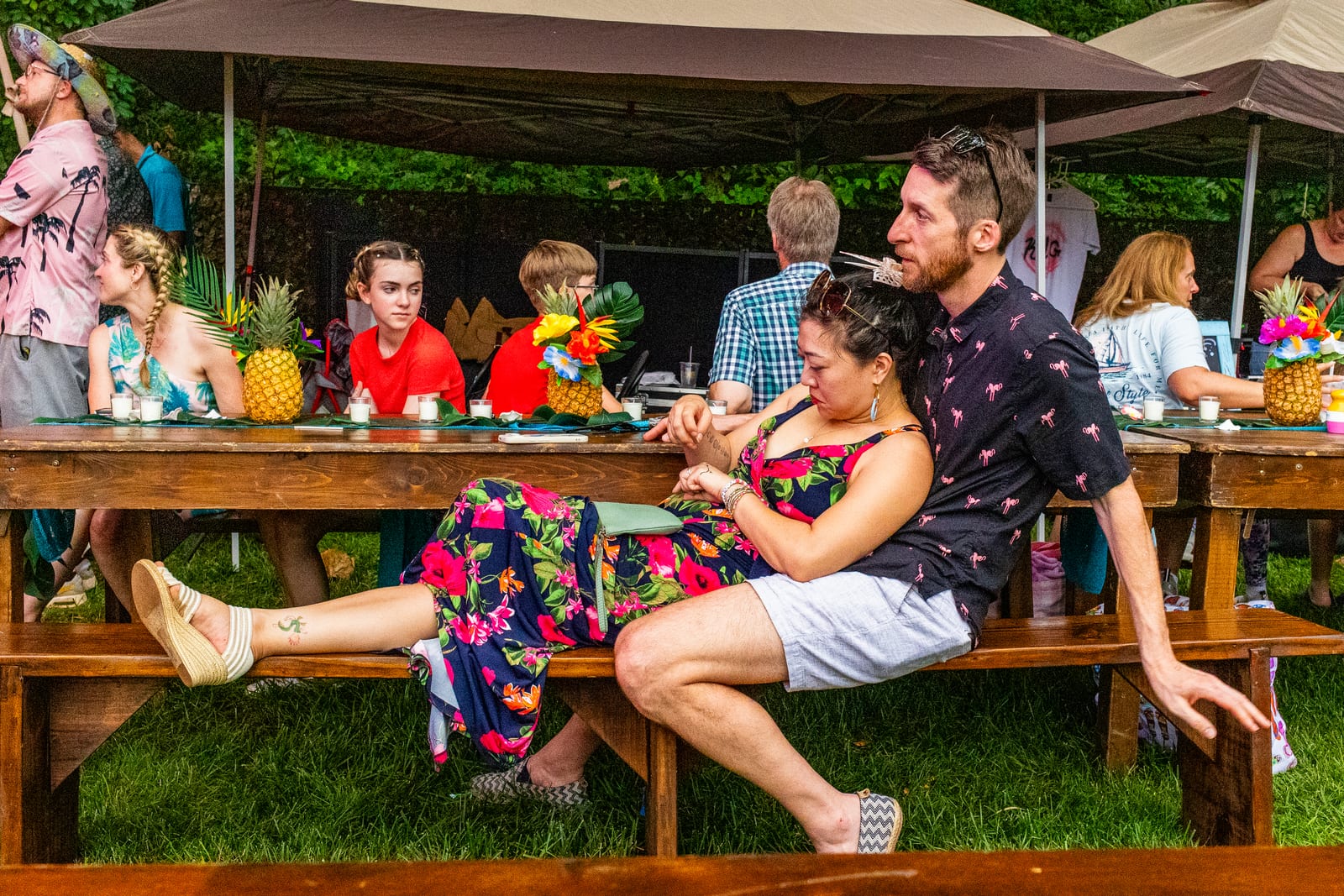 Guests relaxing at a tropical banquet table beneath a canopy