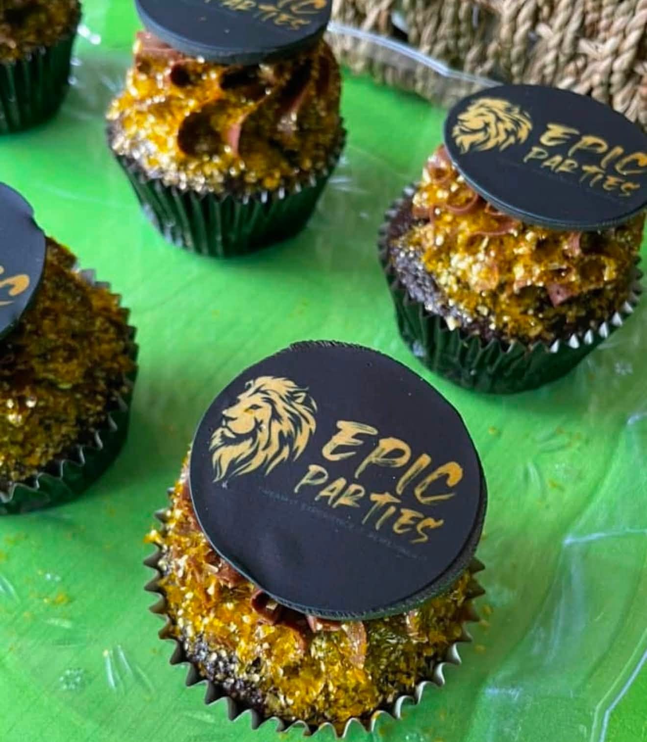 Chocolate cupcakes topped with gold leaf and discs printed with the EPIC Parties lion logo