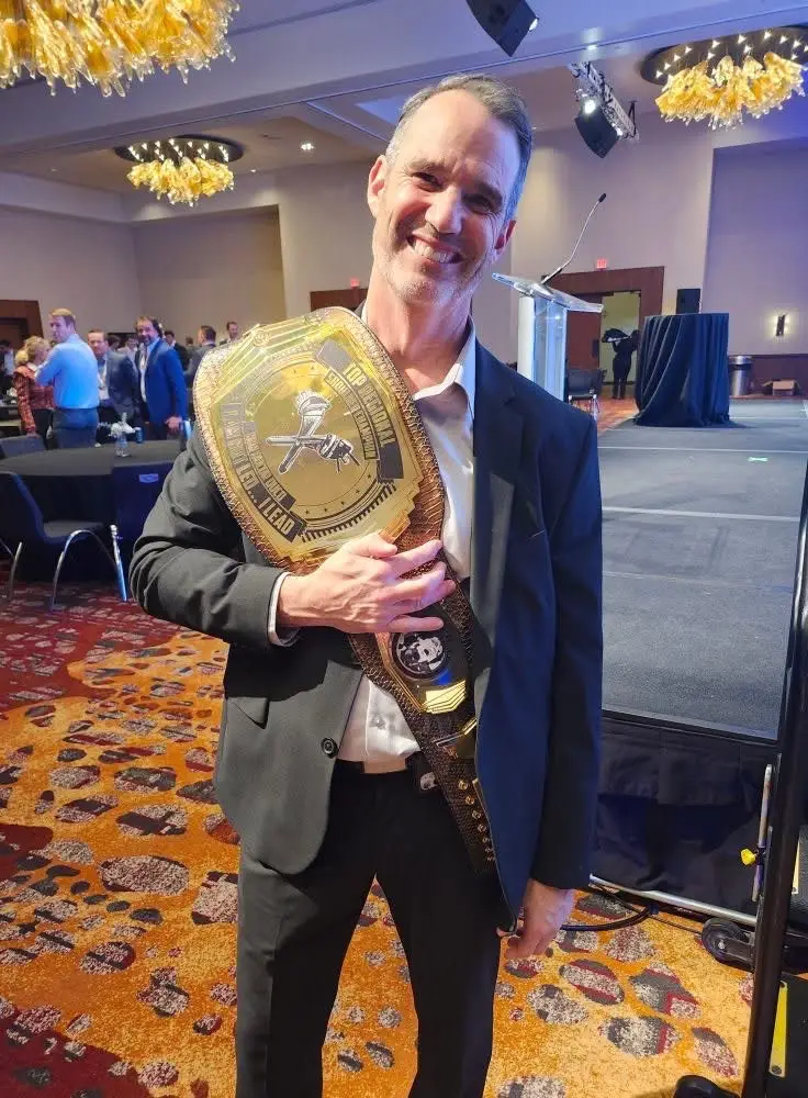 Corporate event guest celebrating with gold balloon decor at EPIC Parties event in Franklin, Tennessee